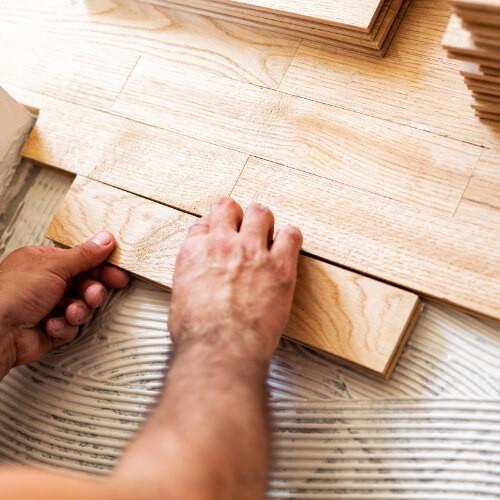 Man installing hardwood flooring | Flooring Direct