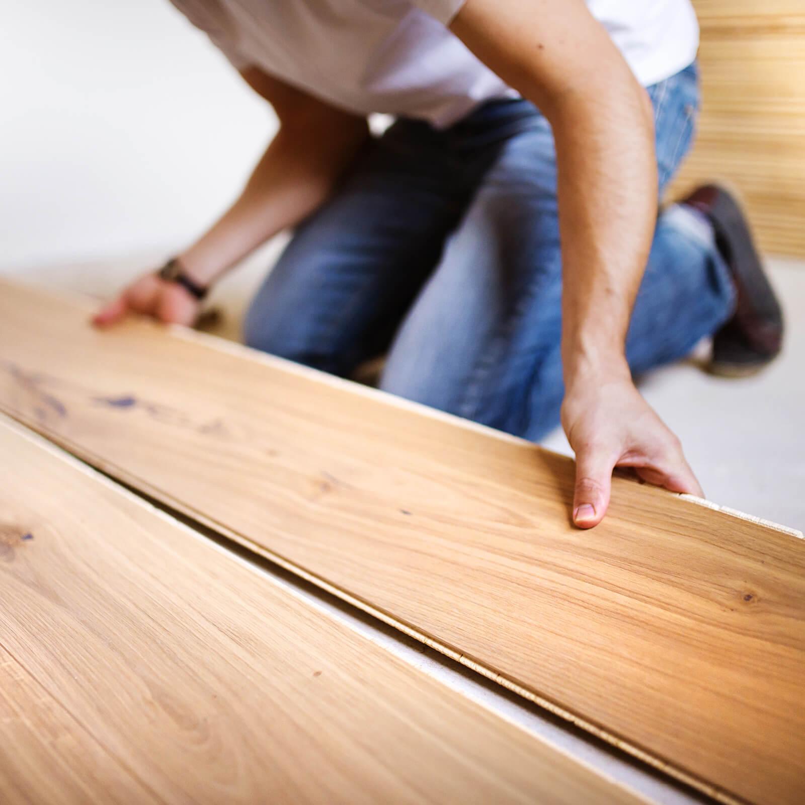 Person installing laminate flooring | Flooring Direct