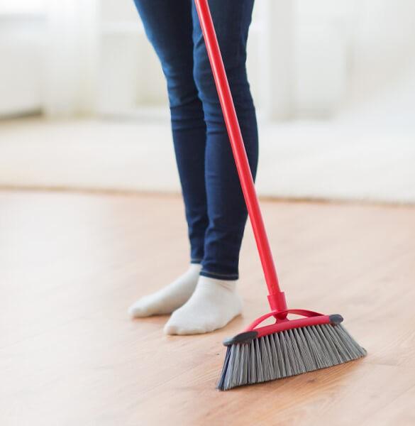 Woman sweeping laminate floors | Flooring Direct