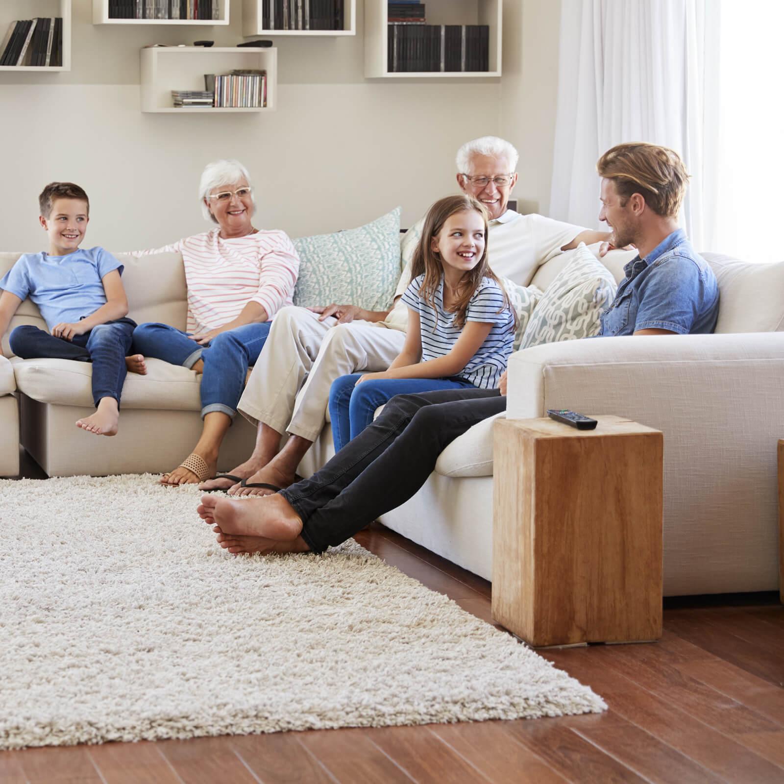 Family chatting together sitting on sofa | Flooring Direct