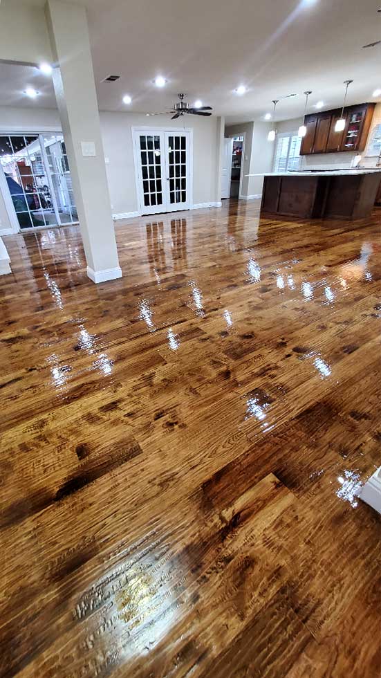 Flooring Direct performs solid hardwood installation and refinishing. This high gloss hickory solid hard wood sanding and refinishing job looks fabulous.