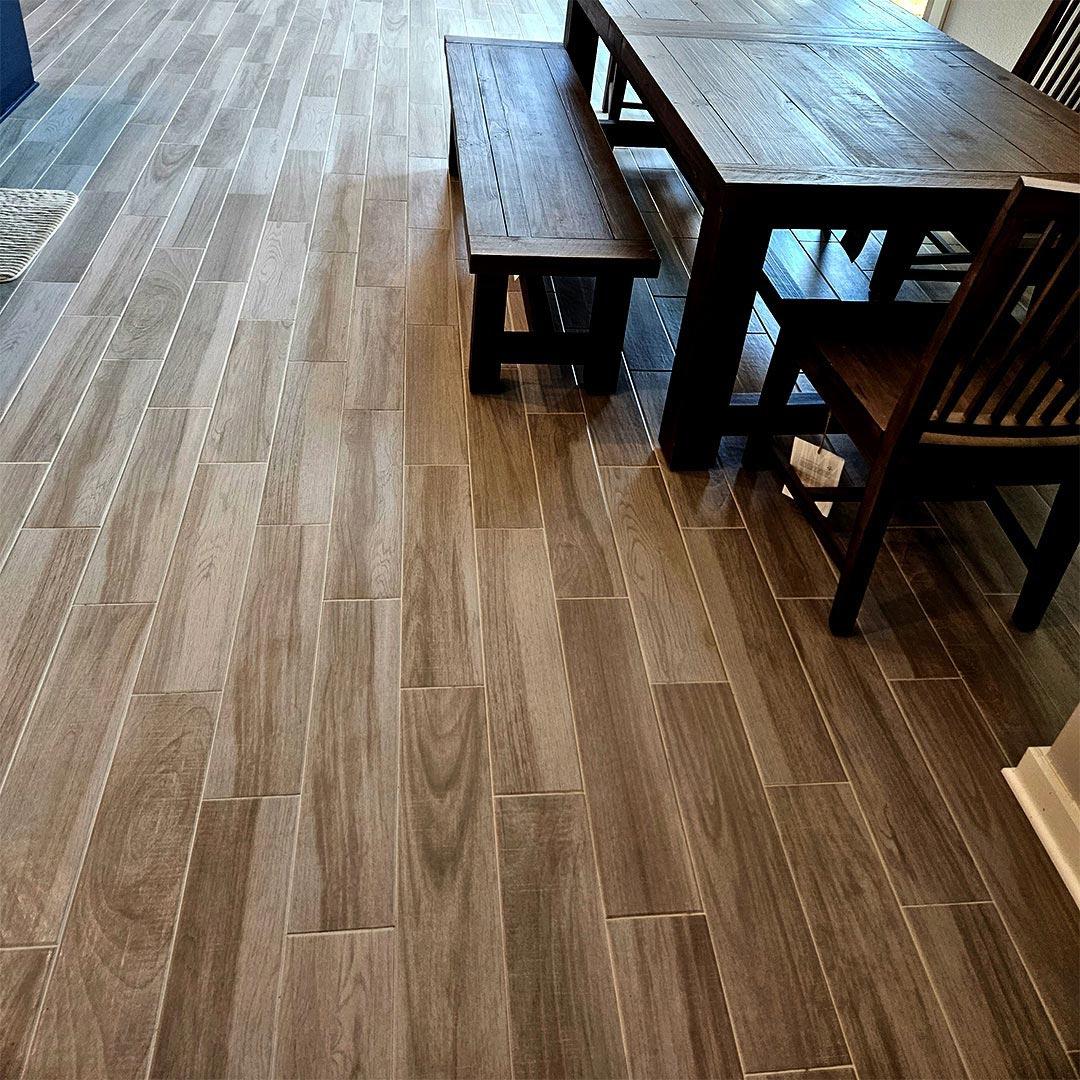 Wood-look Porcelain Tile and Installation performed by Flooring Direct in Grand Prairie featuring a dining room scene.