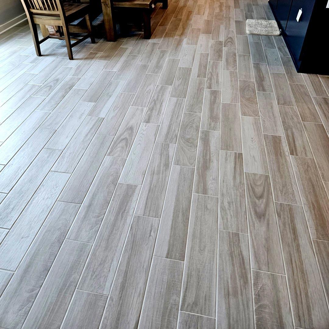 Wood-look Porcelain Tile and Installation performed by Flooring Direct in Grand Prairie featuring a dining room scene.