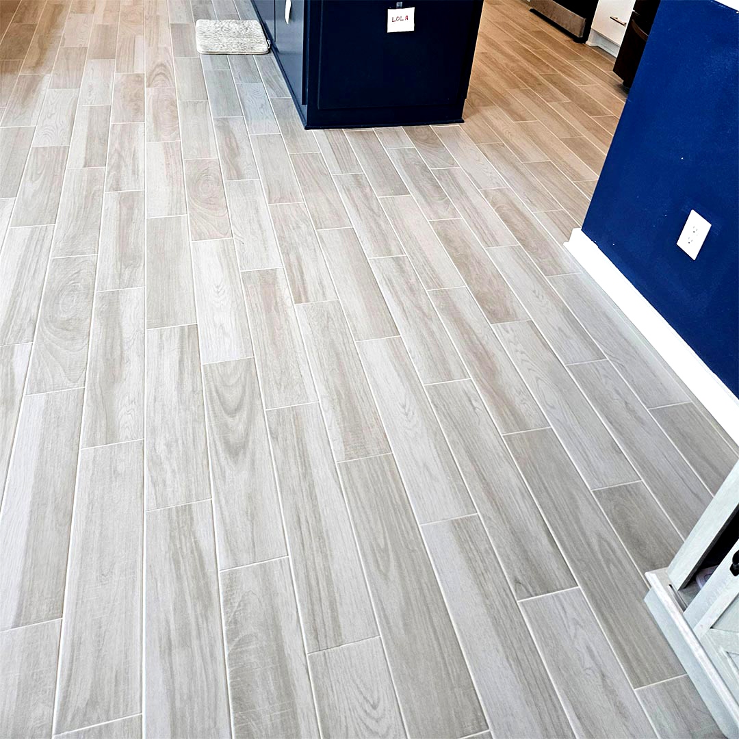 Wood-look Porcelain Tile and Installation performed by Flooring Direct in Grand Prairie featuring a kitchen scene.